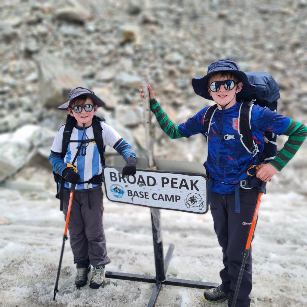Ben and William, two boys standing next to broad peak base camp.  